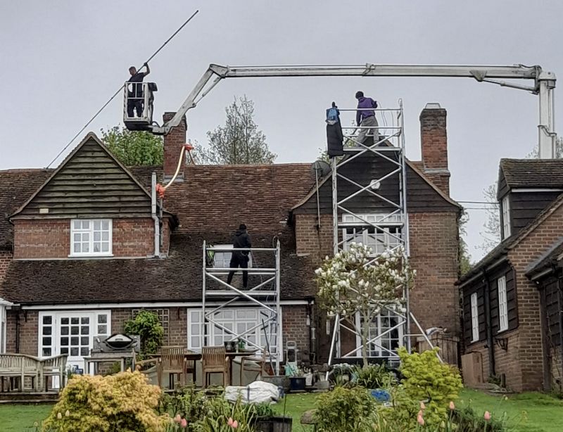 The Roof Moss Cleaners using cherry picker and scaffolding to clean roof safely and professionally in Cheltenham, Gloucestershire